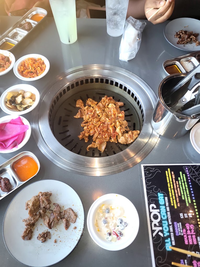 Tabletop grilling with banchan at KPOP BBQ and Bar in Canton