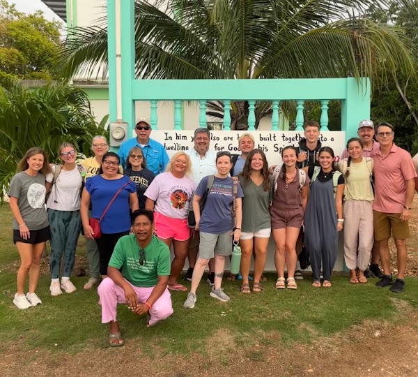 The mission team gathered in front of the Belize Anchor Mission church, June 2026