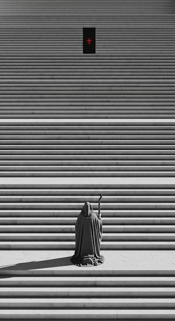 Monochromatic View of Cloaked Figure Kneeling on Endless Steps Toward Dark Gateway - Free mobile Wallpaper