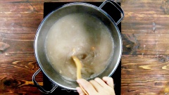 Cho tôm khô ngâm mềm vào nồi nước vừa vớt riêu cua ra và nấu, có tôm khô nước dùng sẽ ngọt và mùi thơm đặc trưng hơn. Pha hỗn hợp gồm 3 muỗng canh giấm, 2 muỗng canh hạt nêm và 1 muỗng canh mắm tôm rồi đổ vào nồi nước dùng, khuấy đều. Cho đậu hũ và cà chua xào vào nồi nước dùng khi đang sôi, thêm huyết rồi đợi đến khi nước sôi lại thì nhắc xuống. Nêm nếm nồi bún riêu cua đồng lại tùy theo khẩu vị của gia đình.