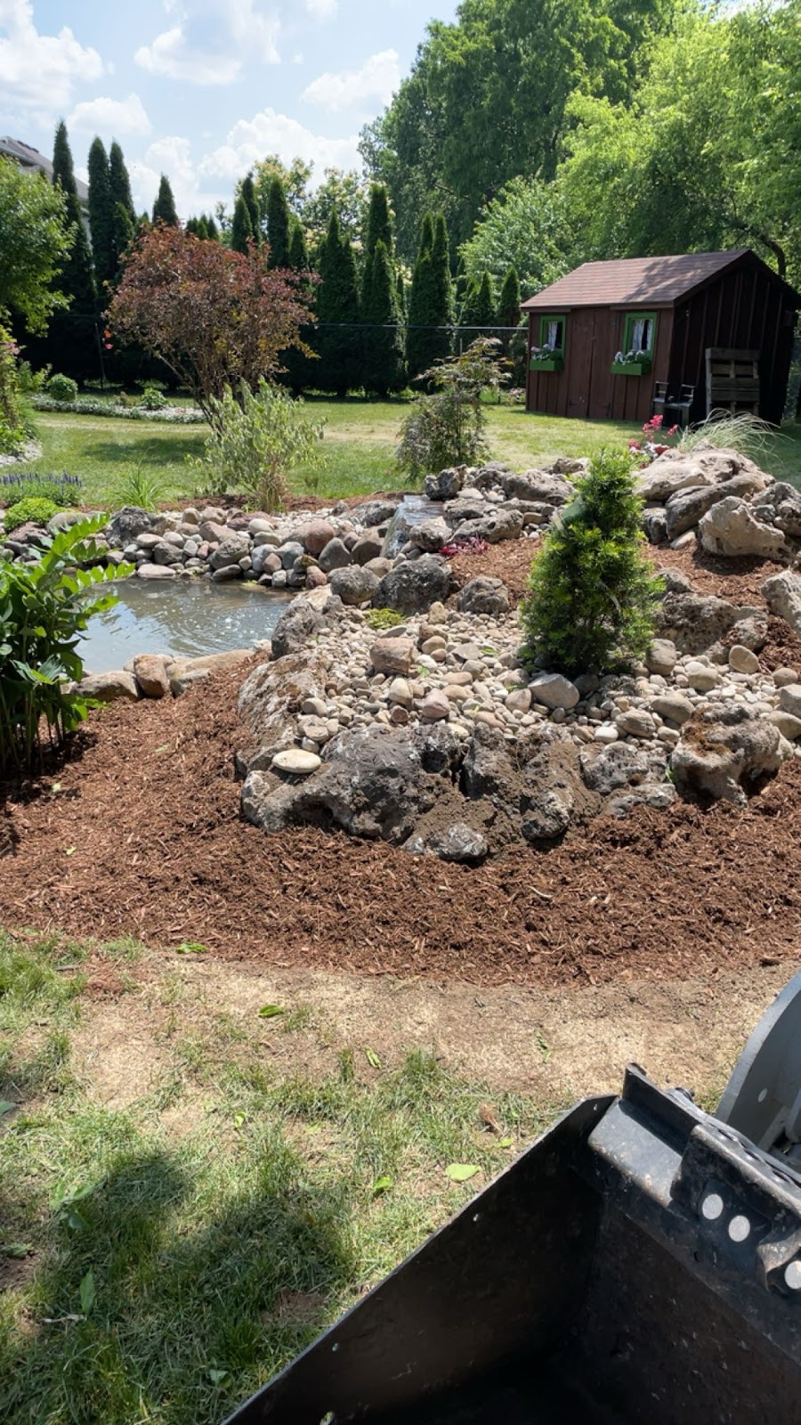 Backyard interlock hardscaping with stone retaining walls in London, Ontario