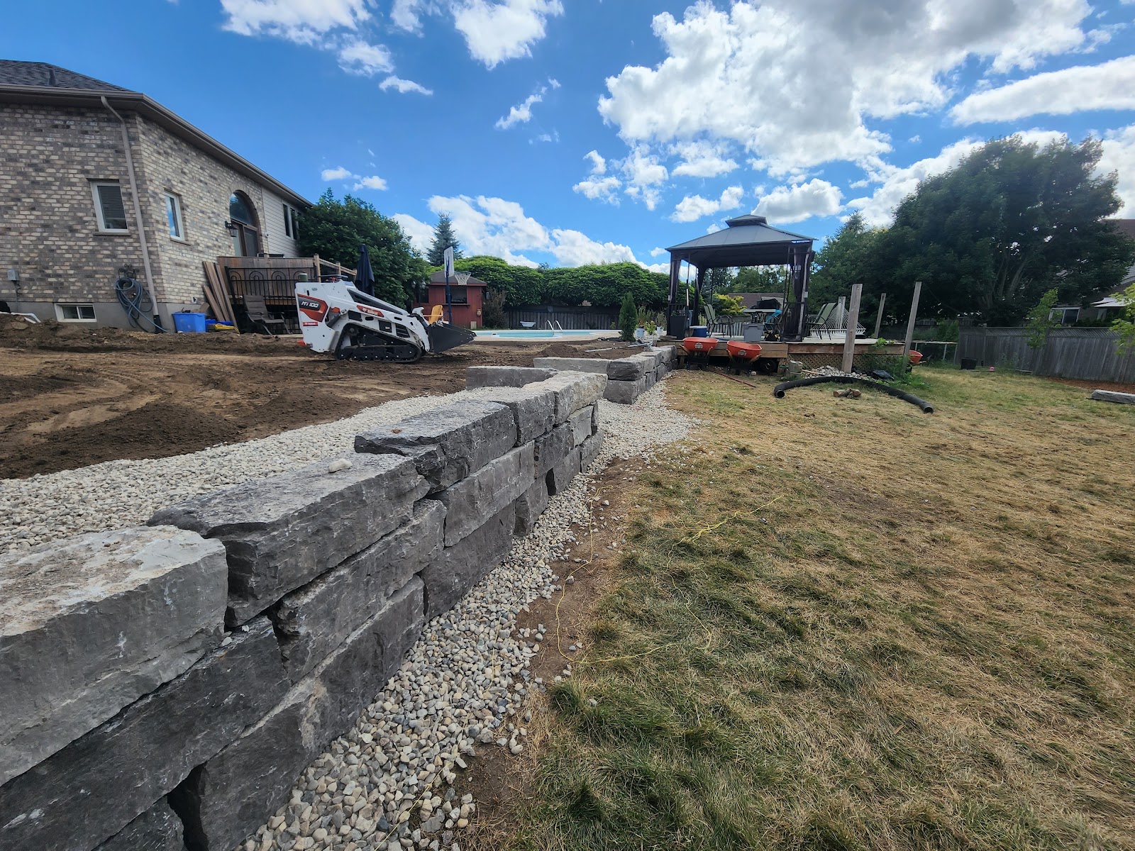 Modern stone patio build with soldier course border in London, Ontario