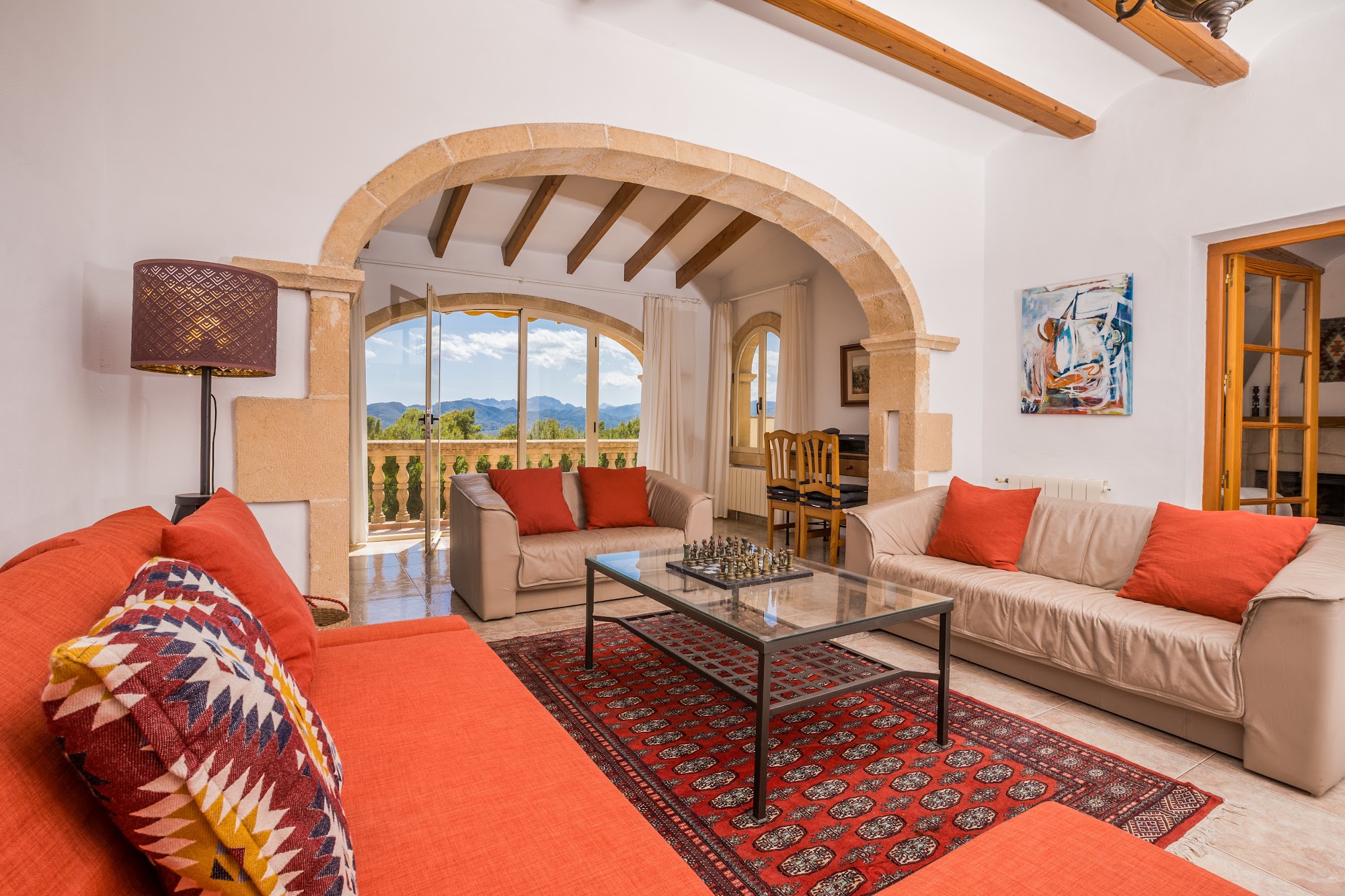 Sitting room with chandelier and orange sofas