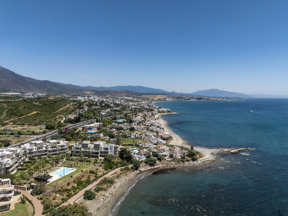 Aerial view of the Sabinillas coastal strip in Manilva showing beachfront residential buildings and the Mediterranean coastline