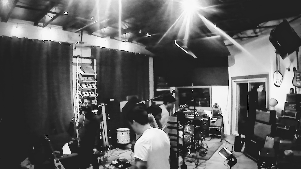 The four members of Luckless while recording their debut EP in the studio
