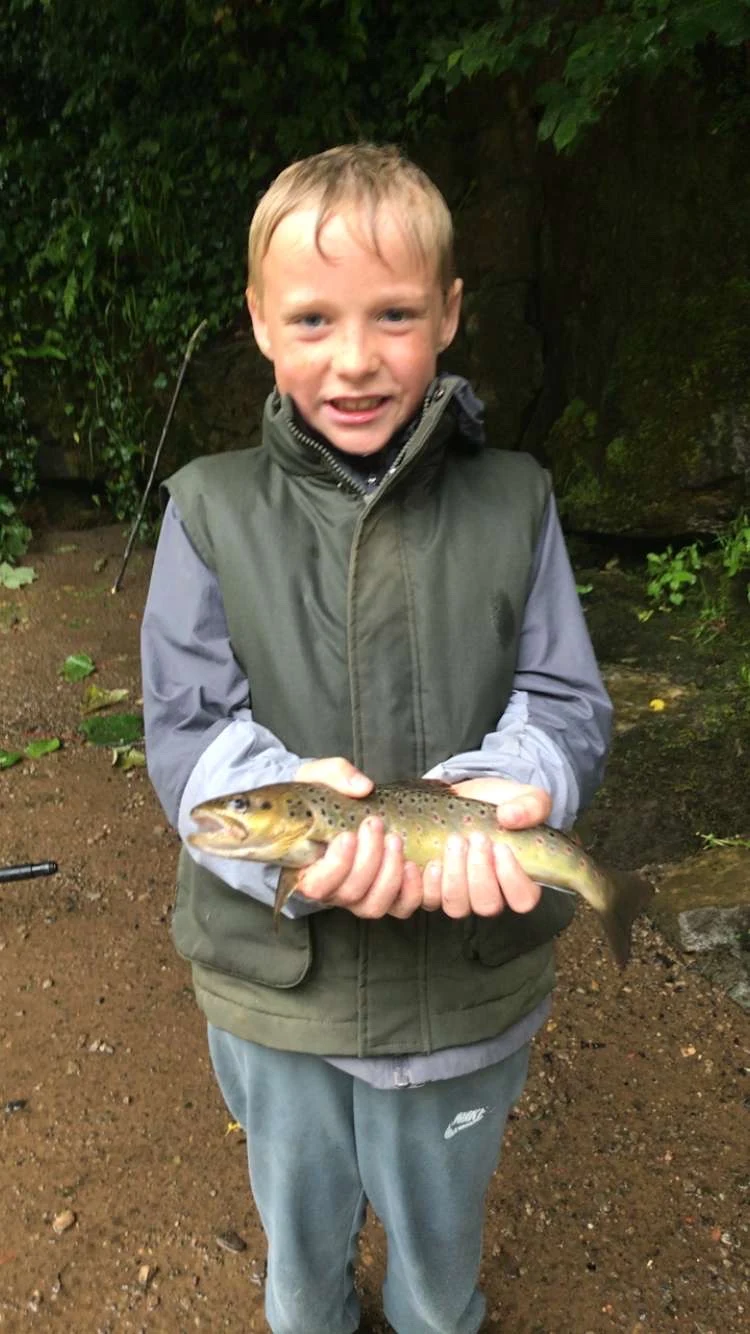 James Cockburn with a Brown Trout caught on a worm on a local river