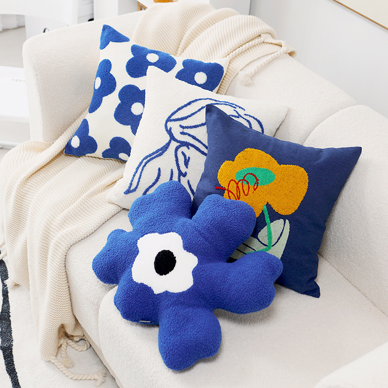 Cushion cover with embroidered daisy motif