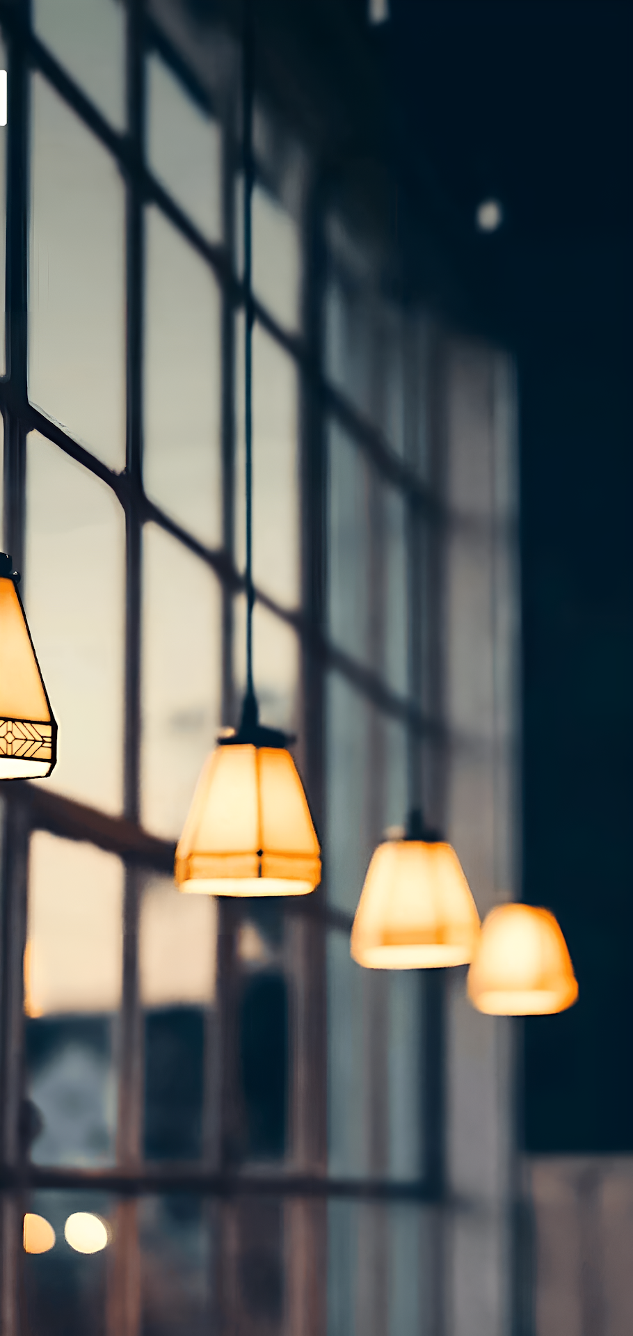 Warm Amber Pendant Lamps in Industrial Setting - Free 4K mobile Wallpaper