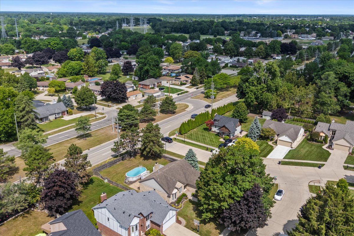 Fenced backyard with above ground pool and deck at 13656 Heatherwood Drive, Sterling Heights, MI