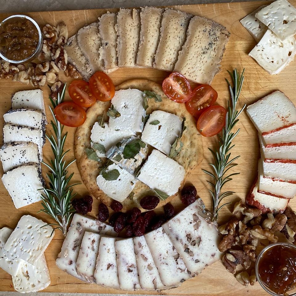 Monte Robledo goat cheeses arranged with tomatoes, rosemary, preserves and nuts.