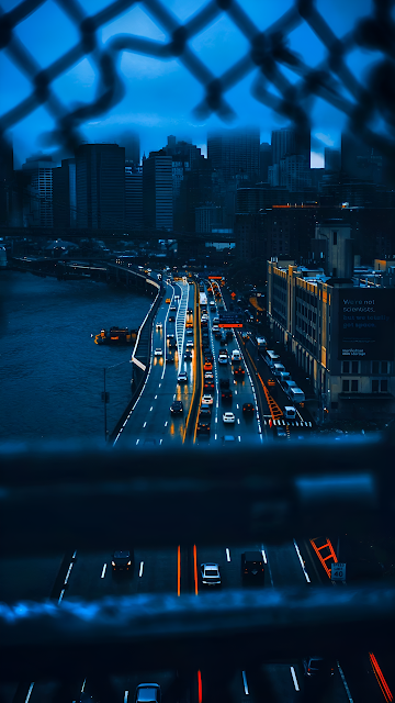 City Highway at Night Viewed Through Chain Link Fence - Free mobile Wallpaper