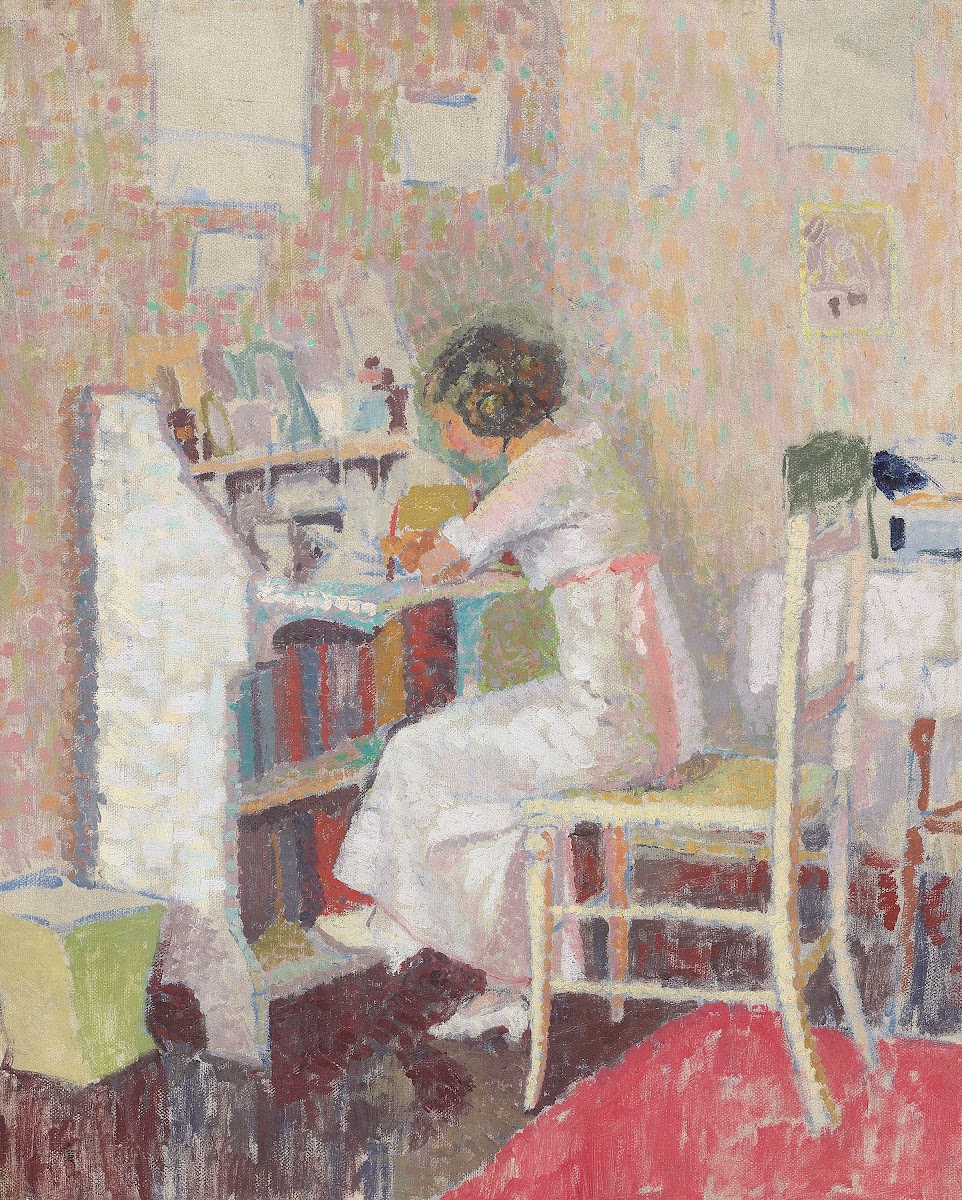 Girl sitting at a writing table circa 1919