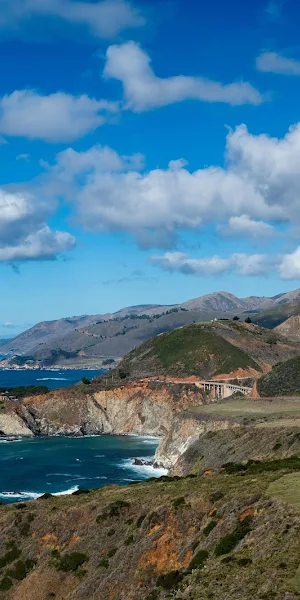 Coastal Cliffs Under Blue Sky 5K Wallpaper Background
