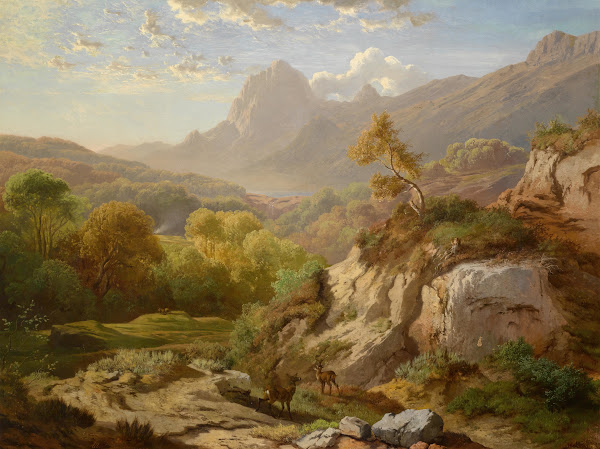 Rotwild in einer weiten Gebirgslandschaft