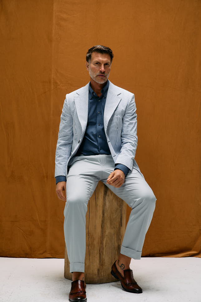 A business casual outfit combination for men: shirt, tailored trousers and a jacket