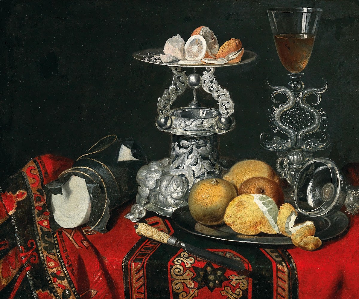 A still life with a Venetian glass a silver vessel and lemons