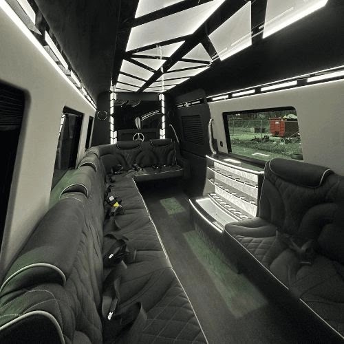 Leather lounge seating, LED ceiling and bar inside the Sprinter Limo