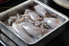 Mực để nguyên con, nhồi thịt vào trong con mực. Gắn đuôi mực, dùng que tăm xiên phần đuôi với thân mực lại và đem hấp 15 phút.