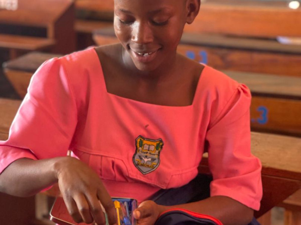 Student writing on classroom blackboard