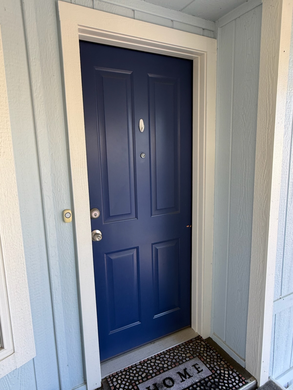 Navy blue entry door and white trim