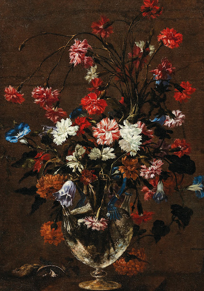 Carnations and other flowers in a glass vase