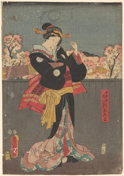 Woman with Black Wrap against Grey Fence cherry trees in bloom in background lat