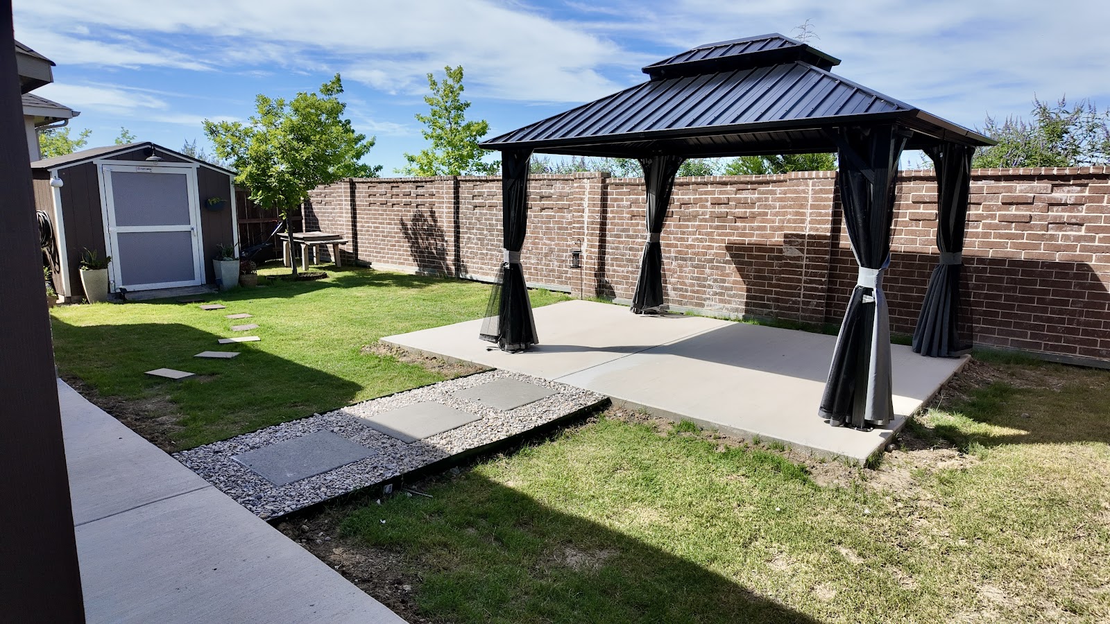 Beautiful concrete patio with gazebo by Abraham & Sons Masonry