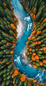 Aerial View of Turquoise River Winding Through Autumn Forest