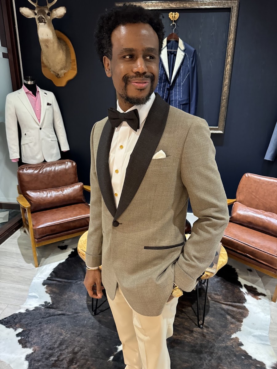 Tan bespoke tuxedo jacket with contrasting dark shawl lapels and gold buttons — formal evening wear by Bespoke By CB Miami