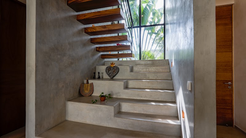 Floating staircase beside a full-height window