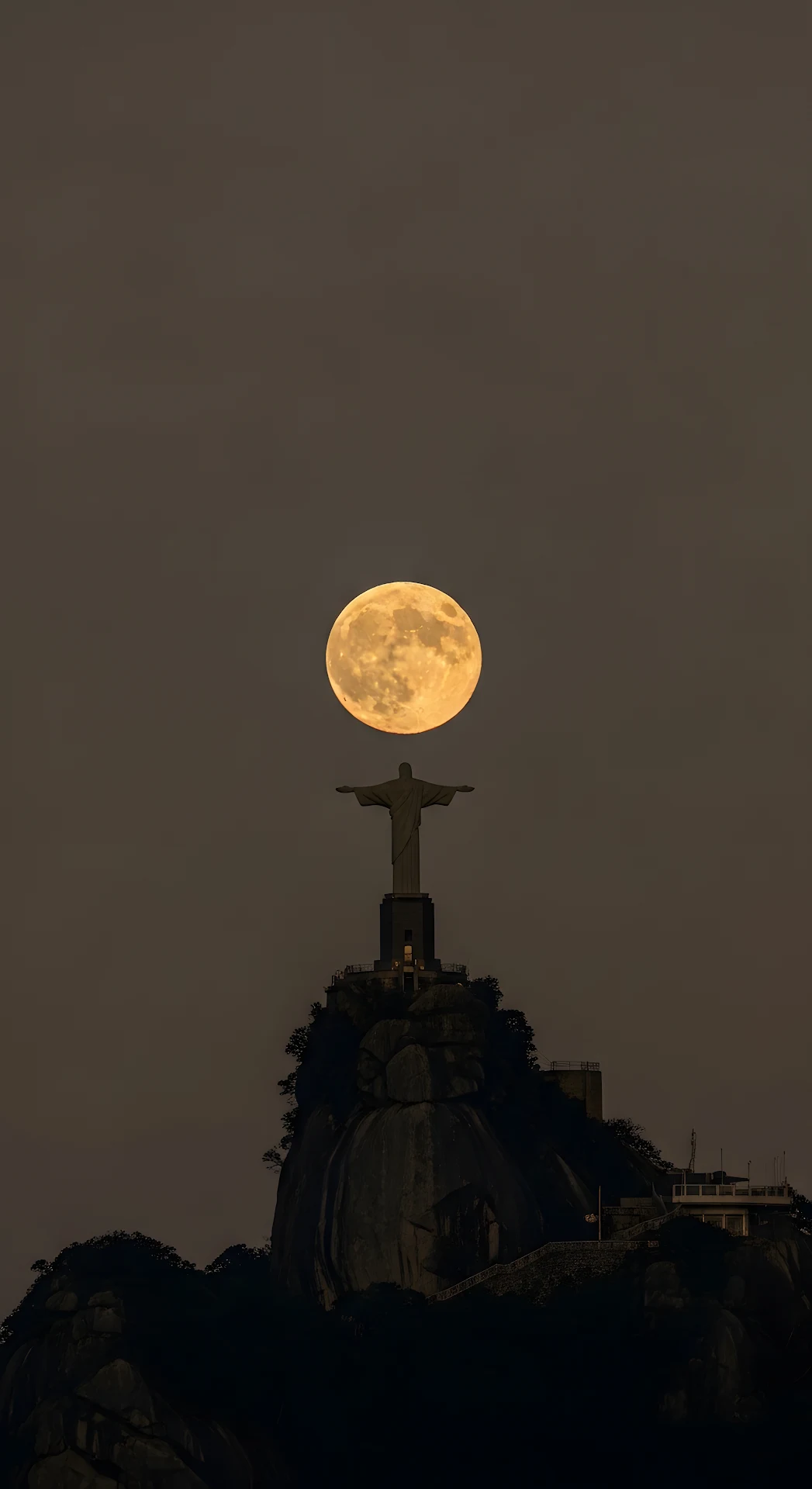 Christ Statue Holding a Giant Full Moon in a Dramatic Dusk Sky - Free 4K mobile Wallpaper