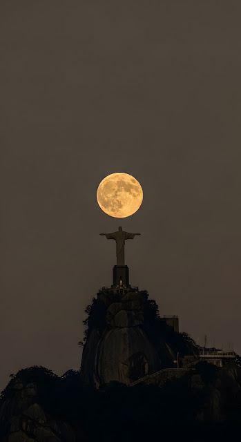 Christ Statue Holding a Giant Full Moon in a Dramatic Dusk Sky - Free mobile Wallpaper