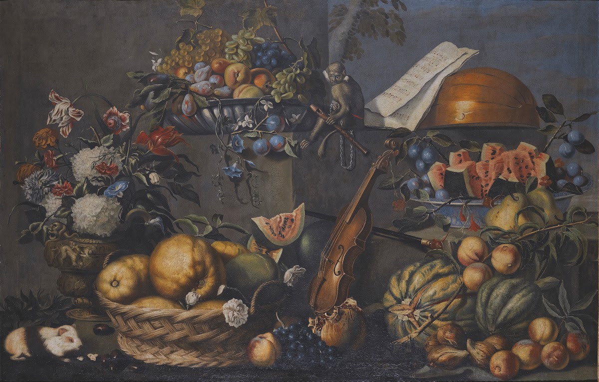 A Still Life With Various Fruits In A Basket And On A Ledge Flowers In A Vase Mu