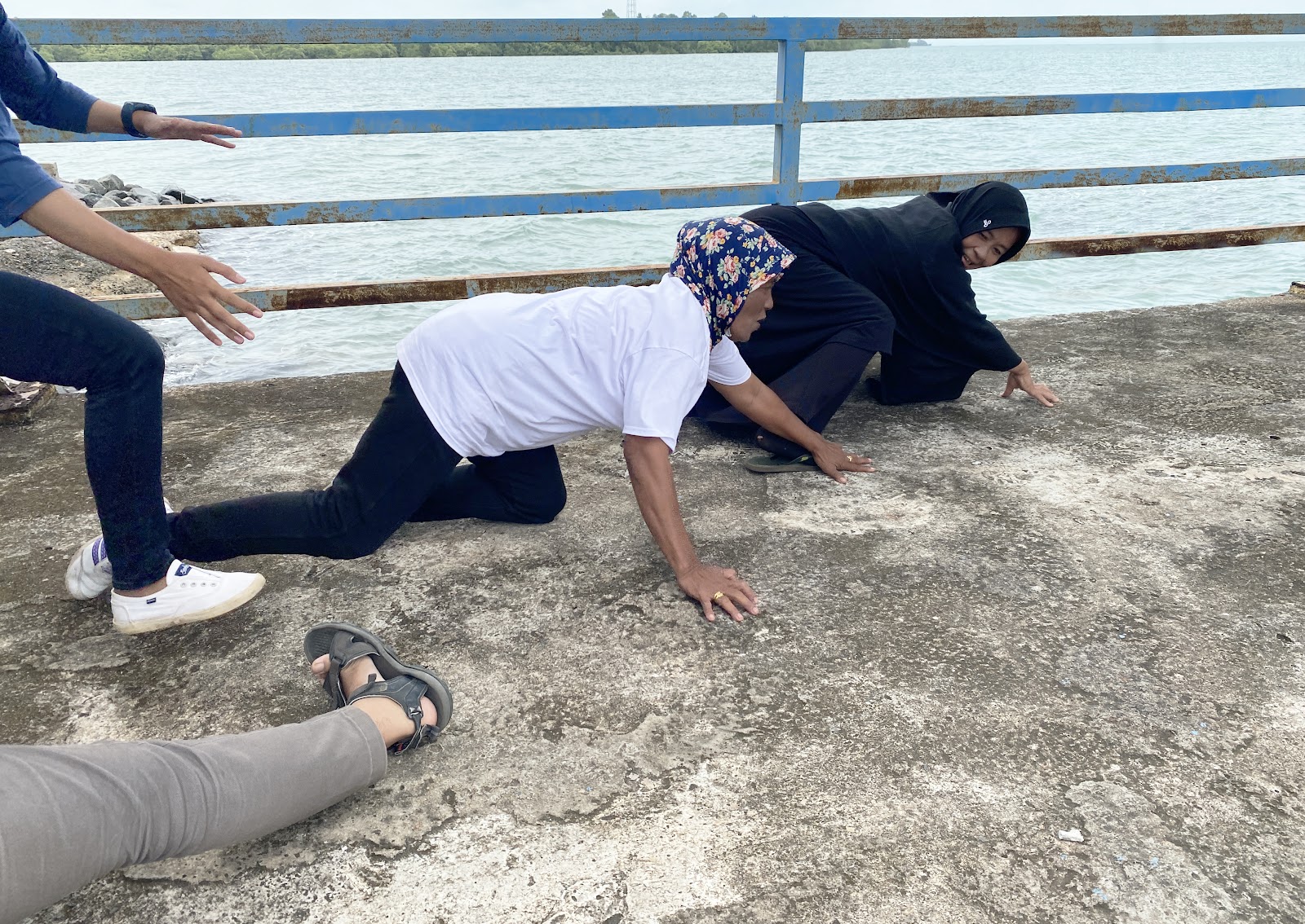 1 CarbonEthics team member posing in training activity with a female PPDL Farmer in hijab and white CarbonEthics shirt