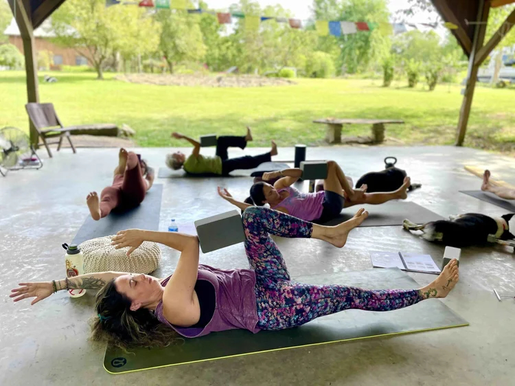 Yoga teacher practicing on wooden floor