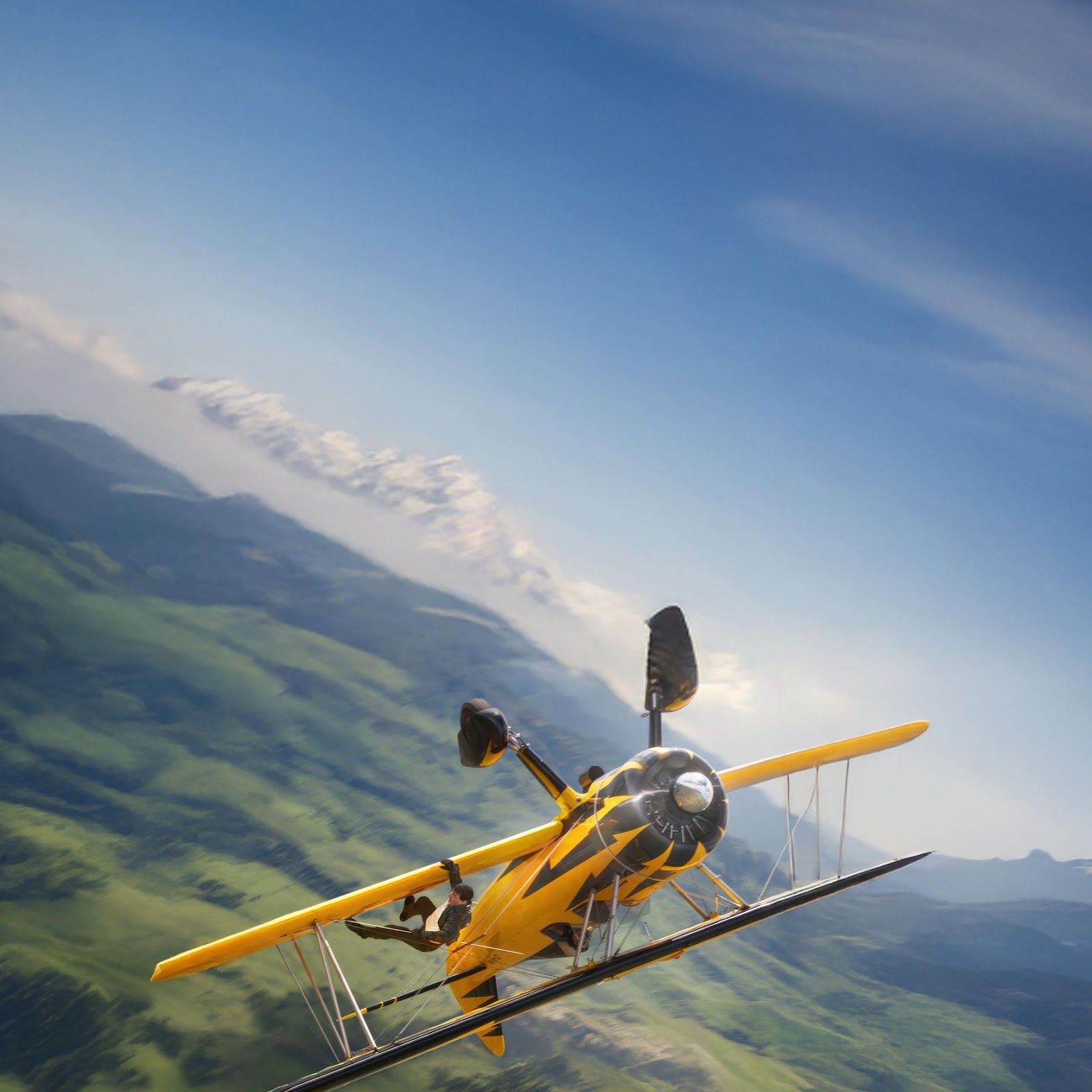 Download Yellow Biplane Flying Over Mountains 2K iPhone