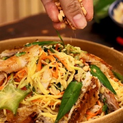 Cho tiếp, ngò rí và rau răm vào trộn đều thêm lần nữa rồi trình bày ra dĩa, tắc thêm chút đậu phộng rang và hành tím phi để món ăn thêm phần hấp dẫn hơn.
