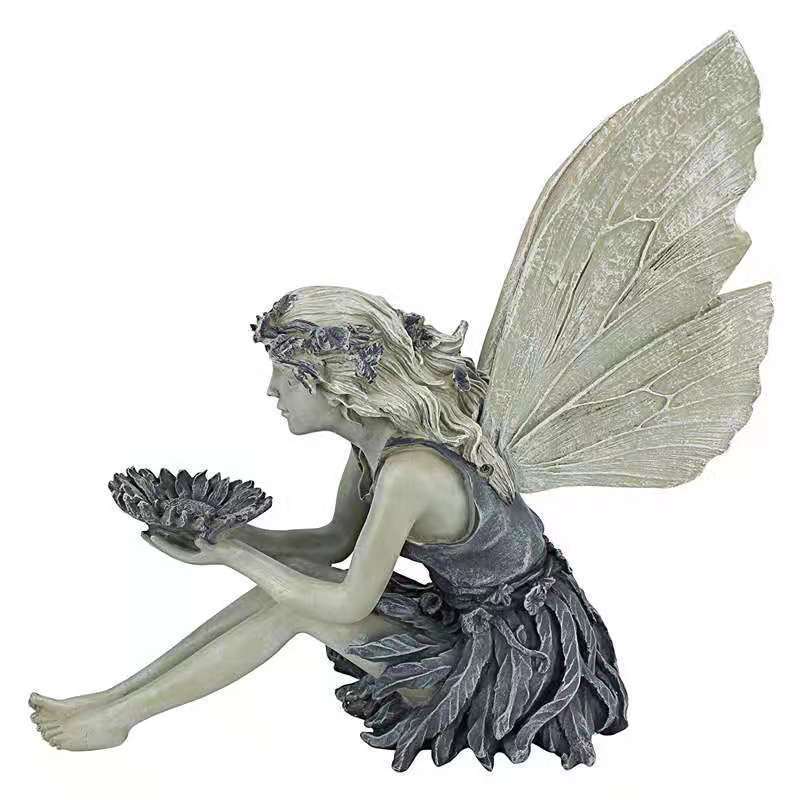 Decorative angel figurine as a birdbath for the garden
