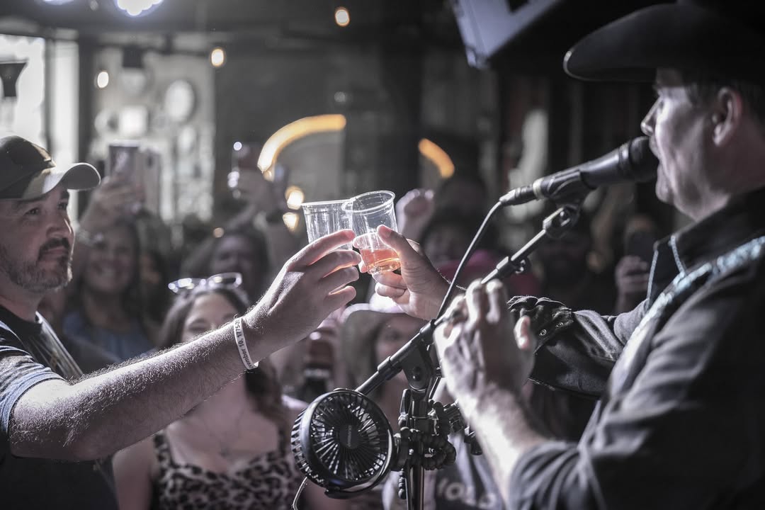 Energetic crowd enjoying live music on the rooftop bar