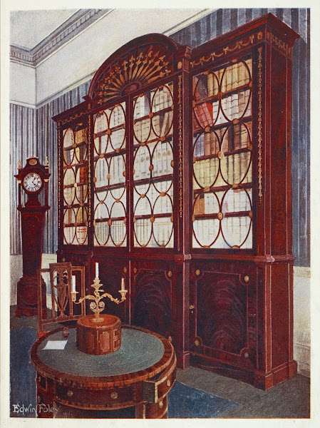 Inlaid mahogany break front bookcase Mahogany pedestal centre table 1910   1911