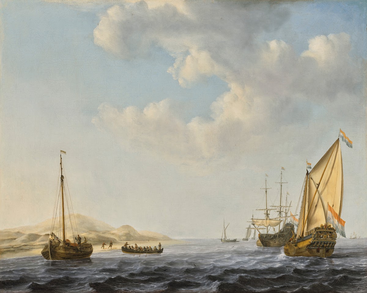 An Amsterdam States Yacht at anchor near the shore with other boats in choppy wa