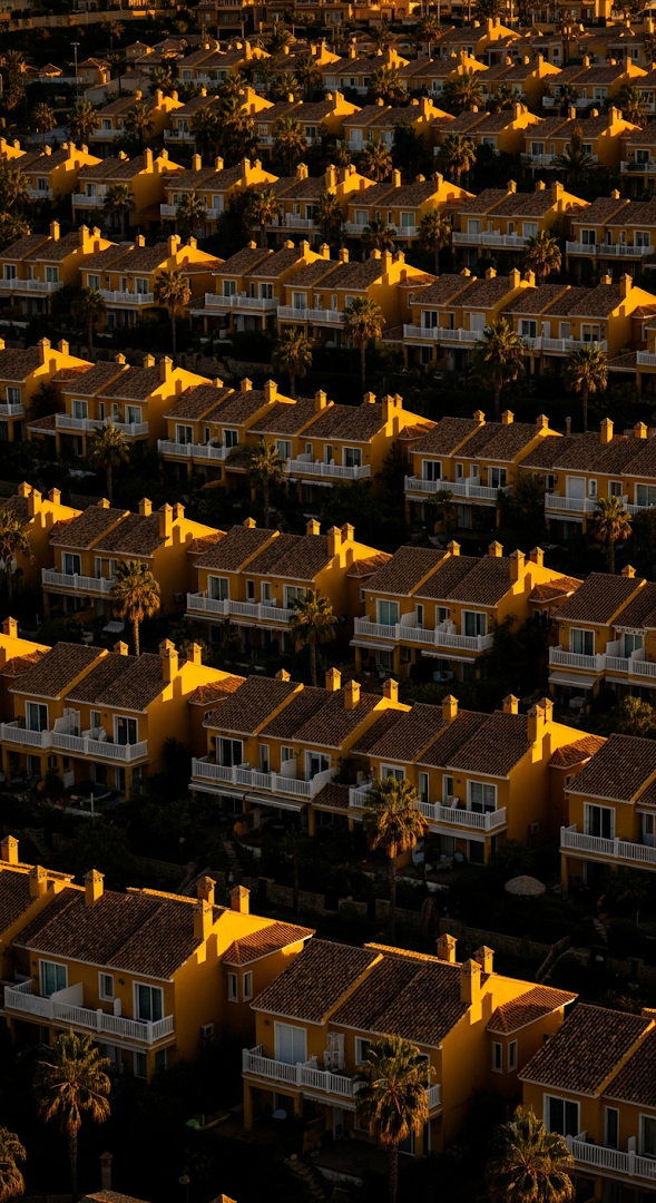 High Angle View of Repetitive Yellow Residential Villas Bathed in Sunset Light