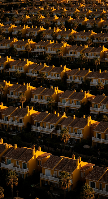 High Angle View of Repetitive Yellow Residential Villas Bathed in Sunset Light - Free mobile Wallpaper