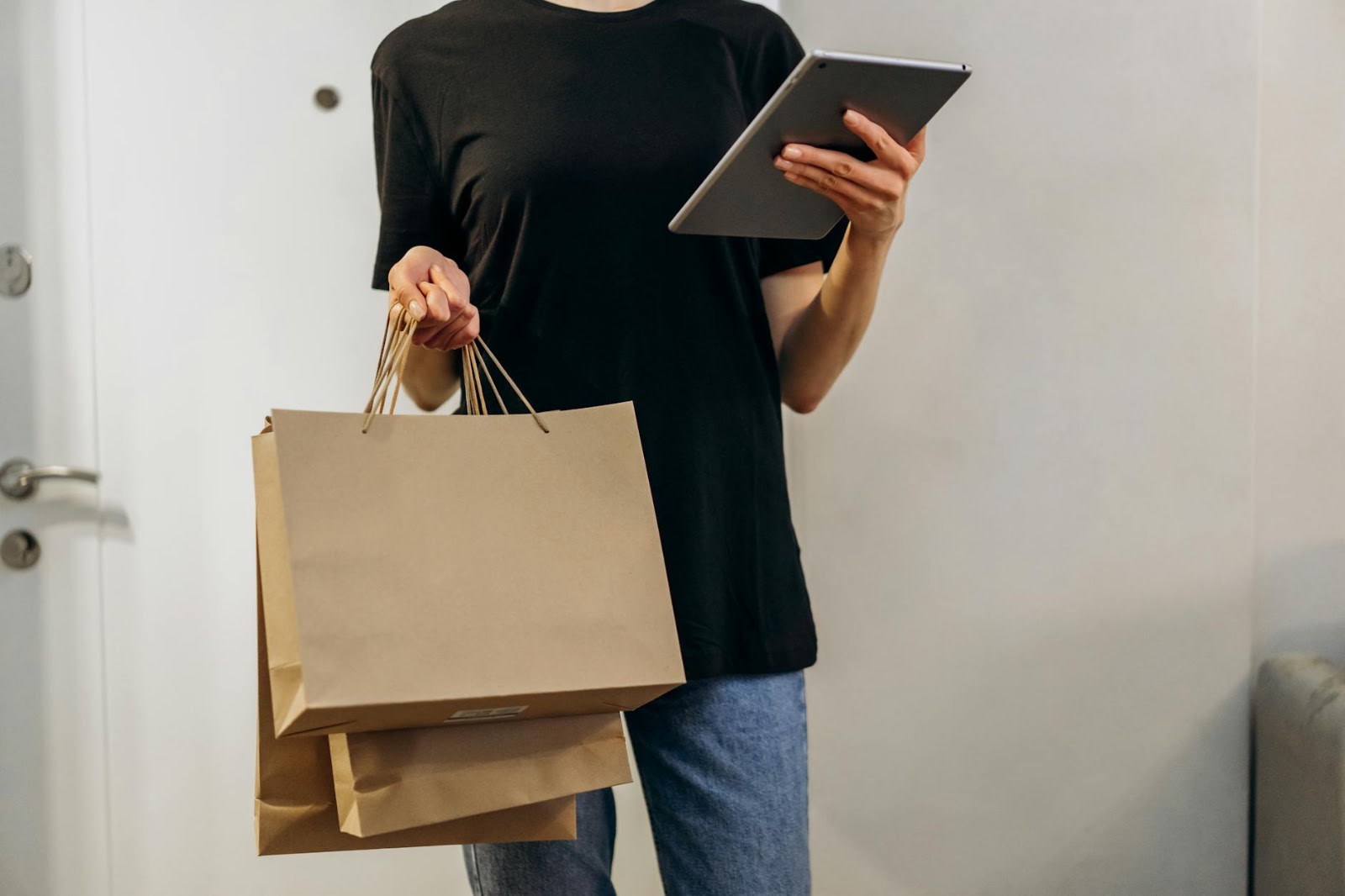 A person comparing prices on a tablet, smart shopping amidst live social media shopping trends.