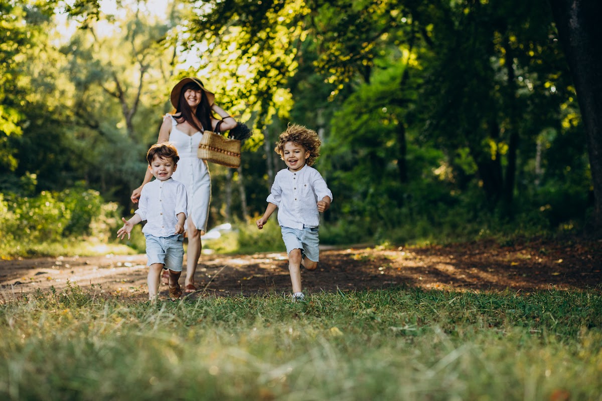 Mother with two sons having fun in park