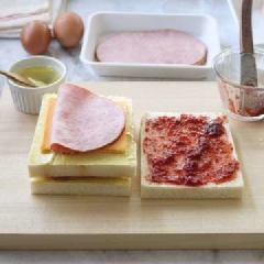 Tiếp tục lấy một lát bánh mì khác đã được cắt bỏ phần viền vàng và phết mù tạt vàng như trên rồi đặt chồng lên nhau. Cuối cùng cho lát bánh mì đã được phết mức dâu lên trên cùng.