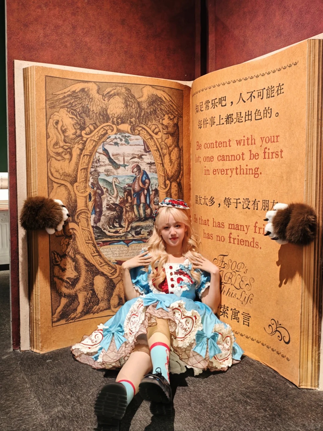 Visitor posing within a giant illustrated fable book