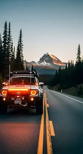 Off Road Vehicle Driving Alpine Road at Sunset