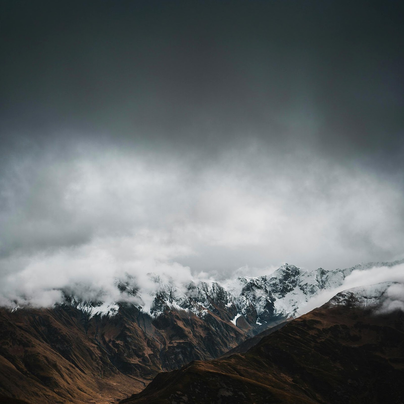 Download Dark Cloudy Mountain Peaks 2K iPhone