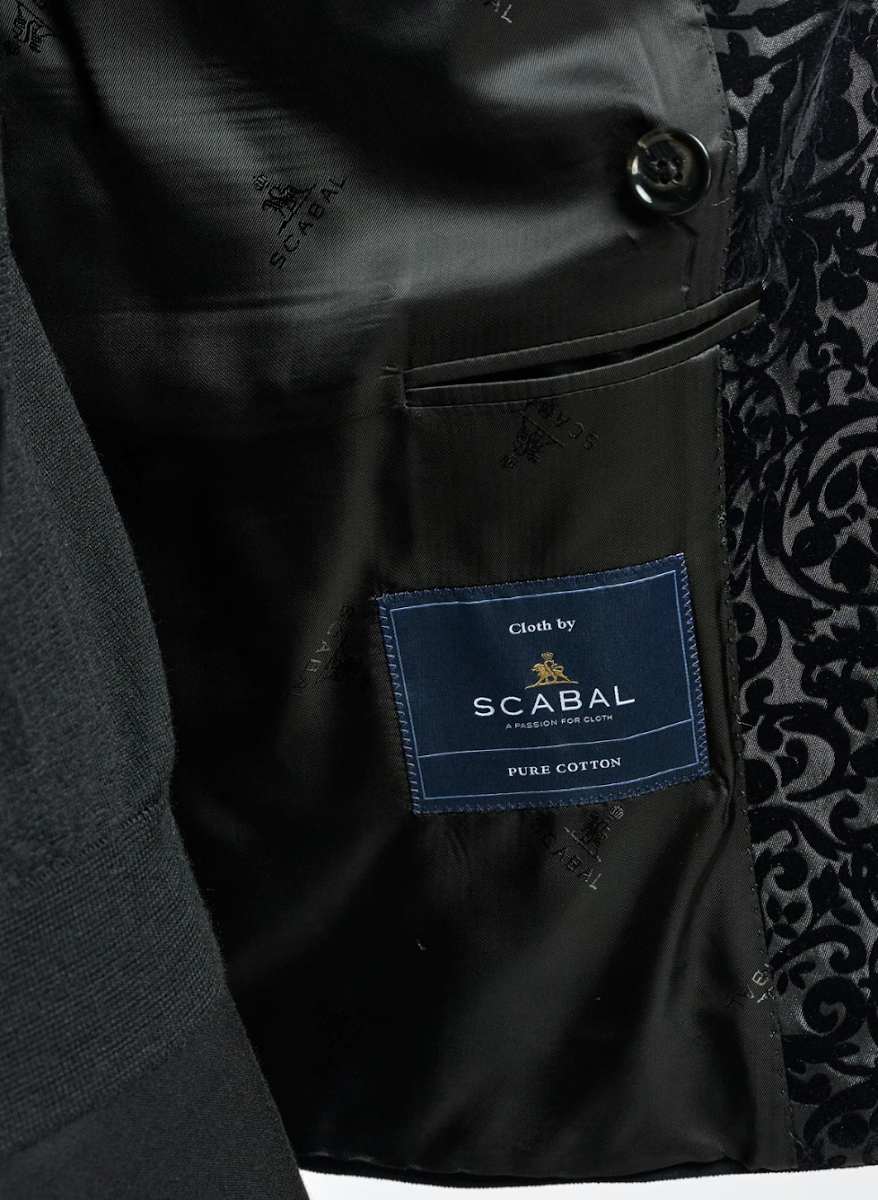 Interior label of a bespoke jacket showing Cloth by SCABAL with Pure Cotton certification — confirming premium velvet construction at Bespoke By CB